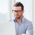 Professional man working on a laptop, promoting IT certification success.