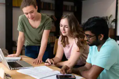 IT certification training with diverse students collaborating on a project.