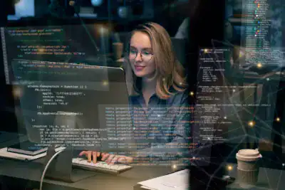 Woman working on coding and IT certifications at Prime Technologies.