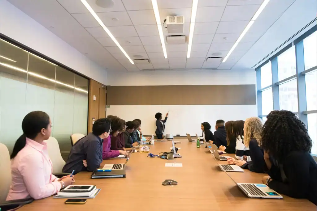 IT training session with diverse professionals in a modern conference room.