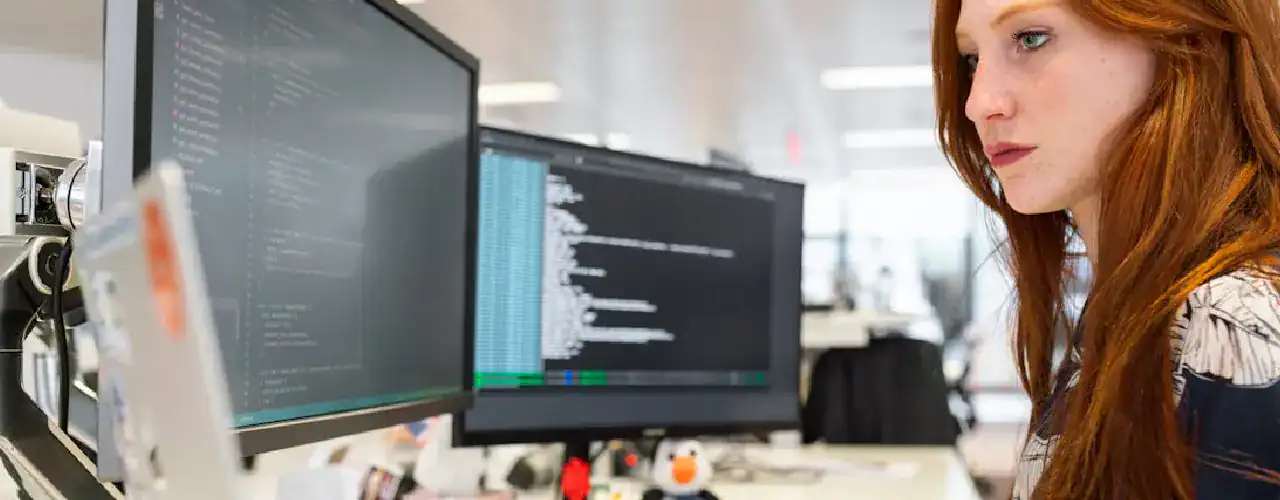 Abstract image representing software development with interconnected elements and the certifying vendor's logo subtly integrated, alongside the Prime Technologies logo, emphasizing core application development skills.