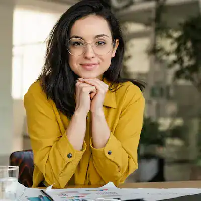 Woman with glasses smiling, promoting hybrid cloud certification training.