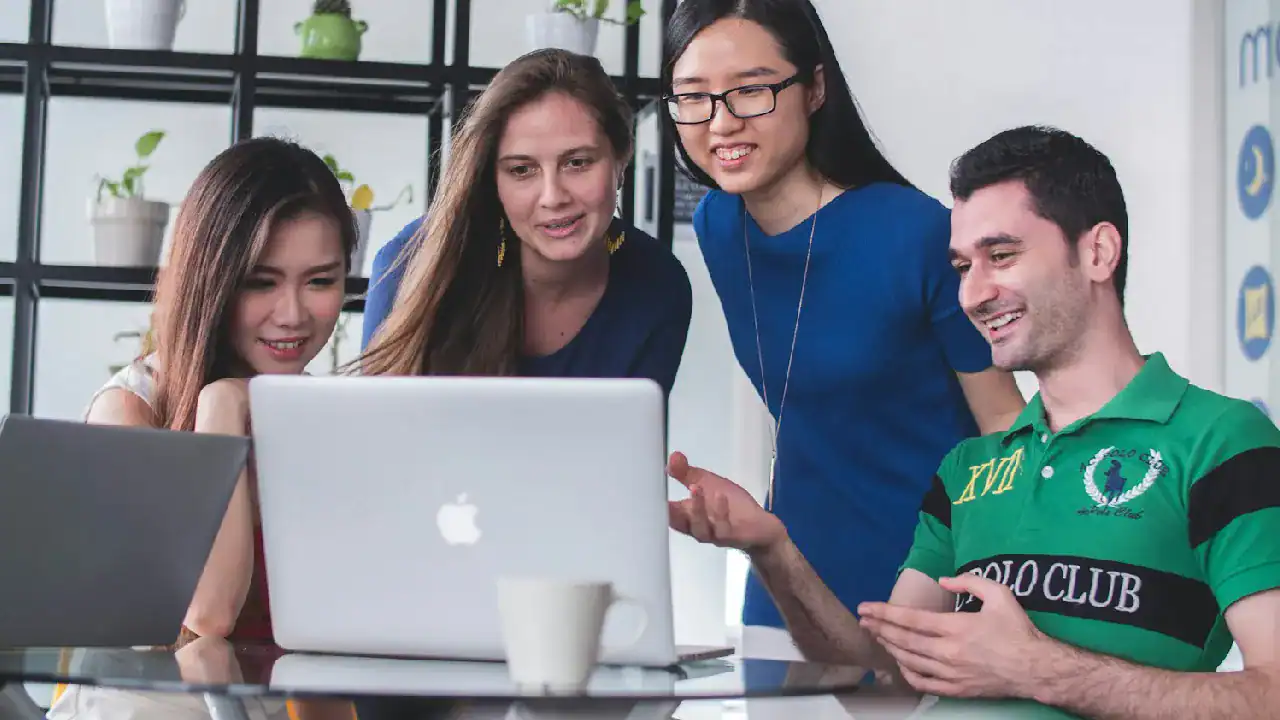 Group of diverse professionals studying AWS certification together.