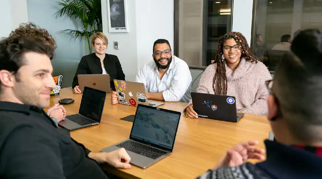 Group of diverse professionals collaborating on security automation at a meeting.