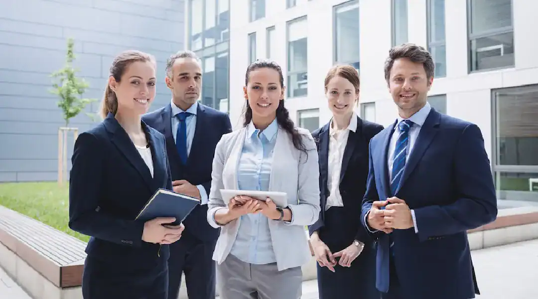 Business professionals discussing networking strategies outside a modern office building.