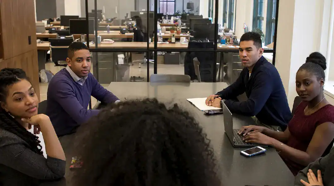 Business team discussing IT certifications in a modern office.