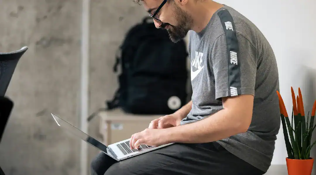 Man studying Juniper JN0-104 networking certification on laptop.