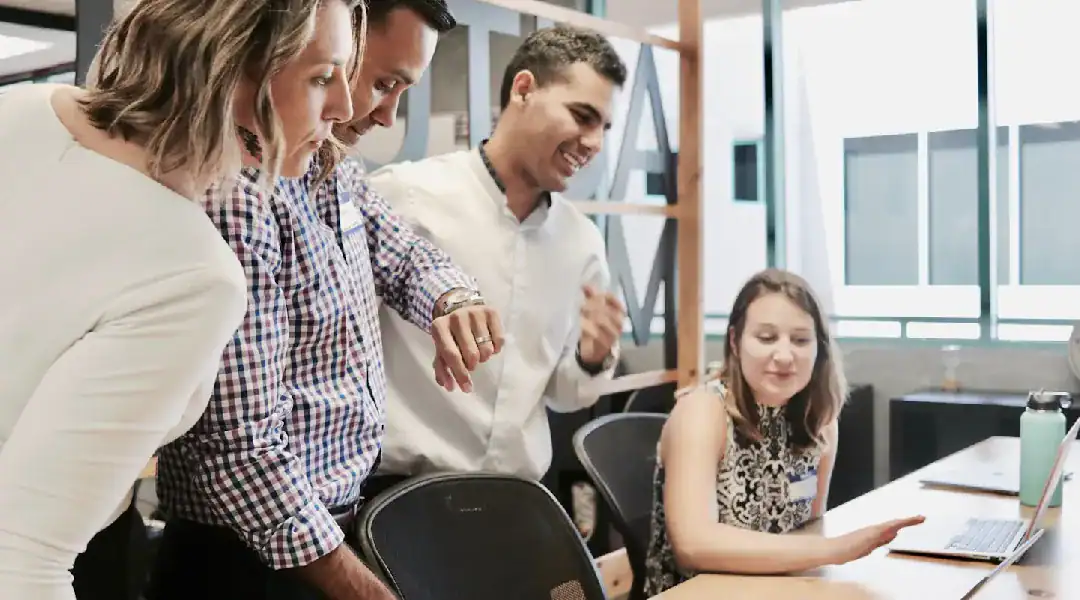 Team collaborating on IT certification training in a modern office.