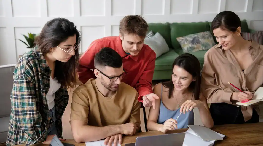 Group of diverse students studying and discussing IT certifications together.