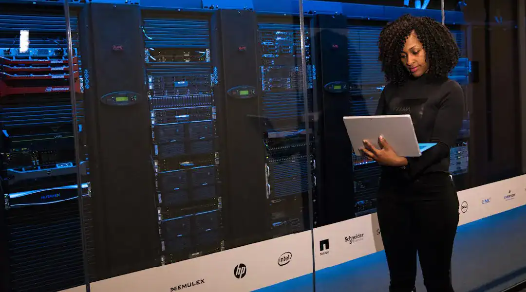 IT professional reviewing server hardware in a data center environment.