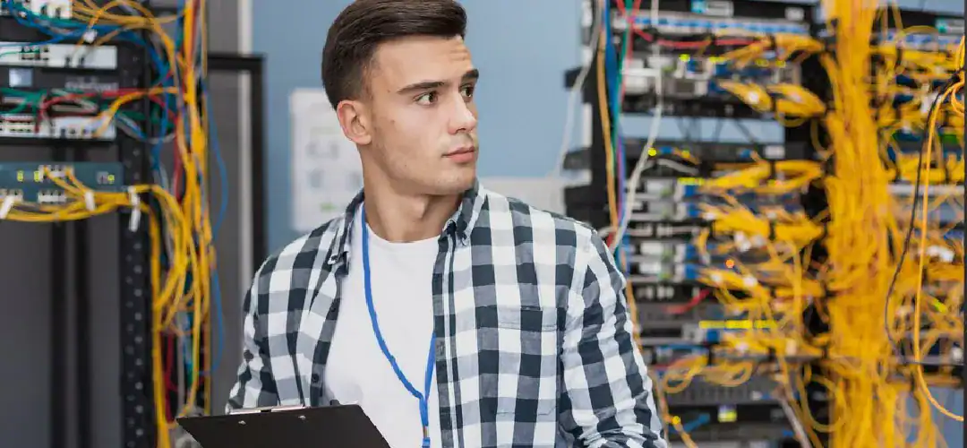 Young IT professional working on cloud infrastructure in a data center.