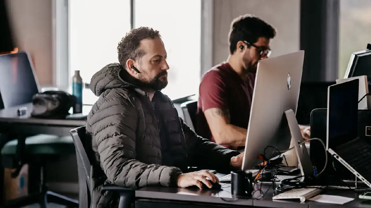 Professionals engaged in IT certification training at a modern office.
