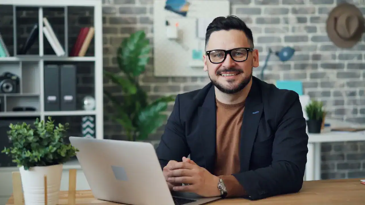 Professional man with laptop promoting AWS ANS-C01 certification.