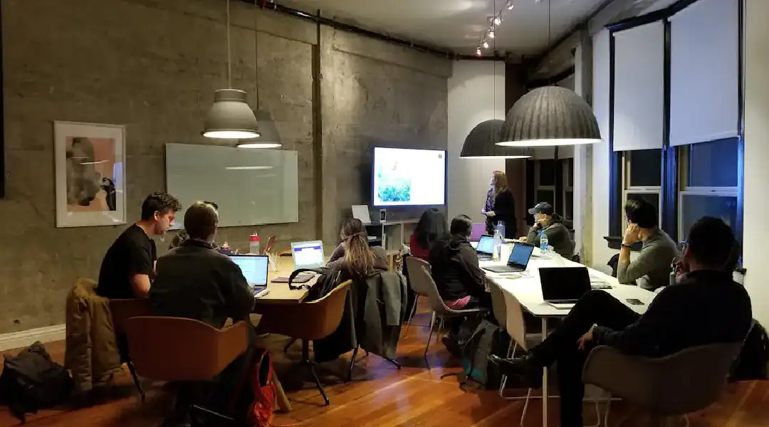 Group of professionals attending a tech training session in a modern conference room.