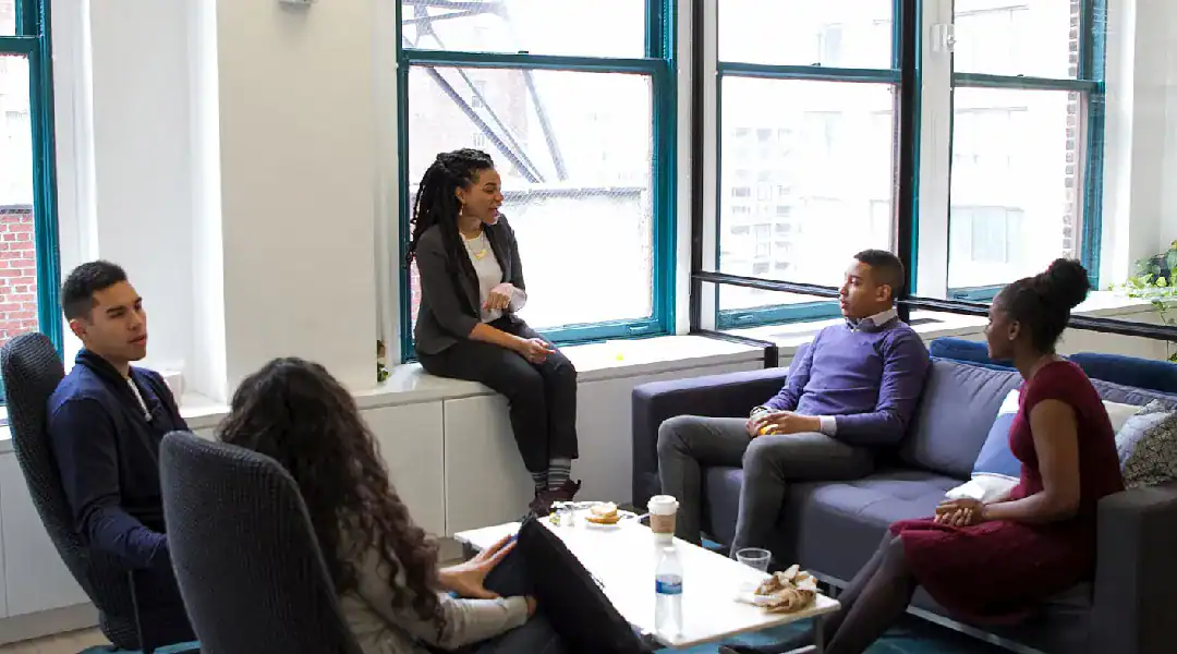 Group of professionals in a career counseling session in a modern office.