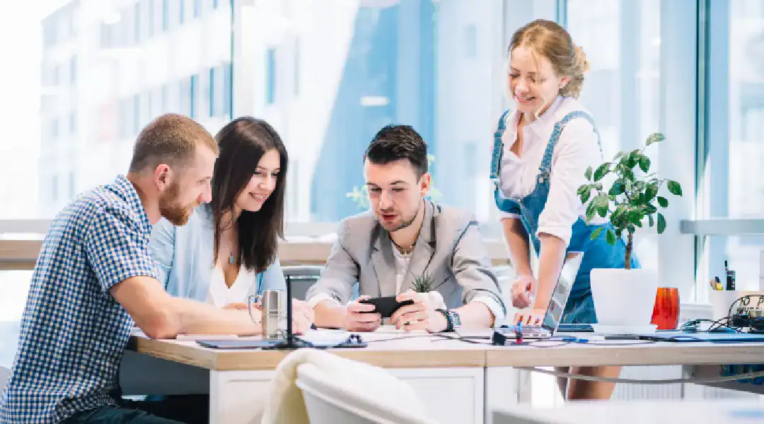 Team of professionals collaborating on IT certification in a modern office.