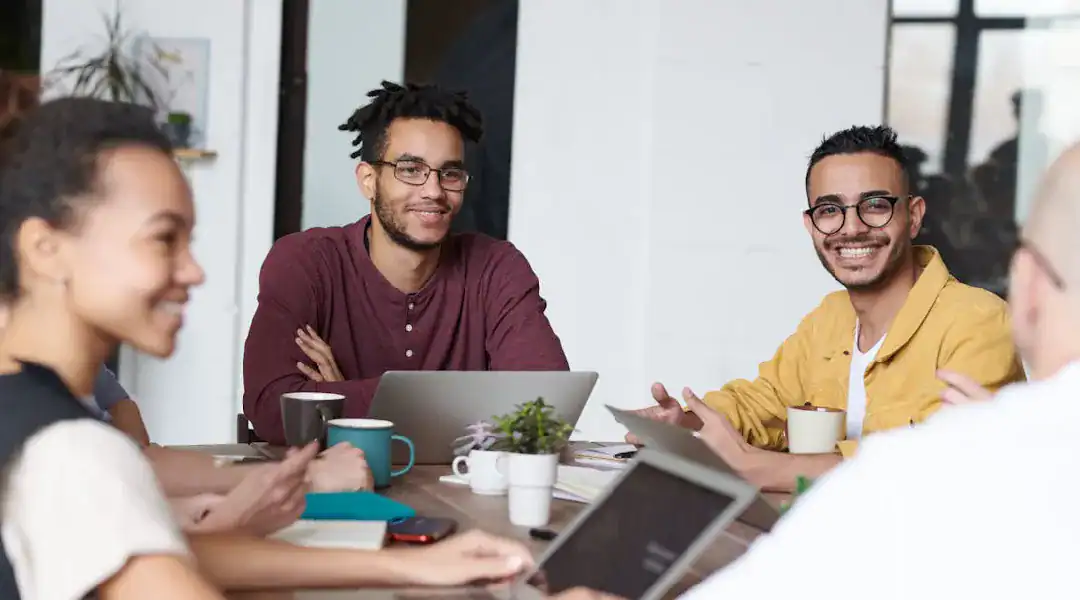 Group of diverse IT professionals in a meeting discussing certifications and career growth.