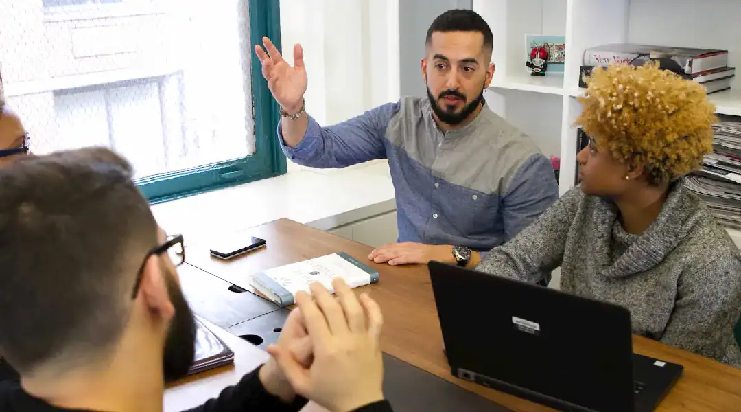 Business professionals discussing IT certifications in a meeting room.