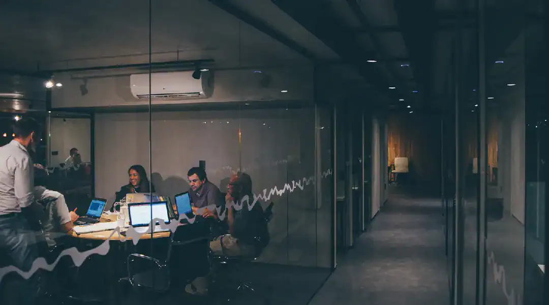 Business team collaborating in a modern office meeting room.
