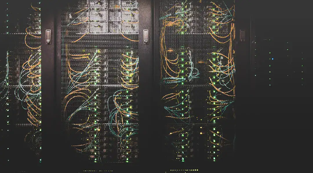 Server racks with network cables and blinking lights.