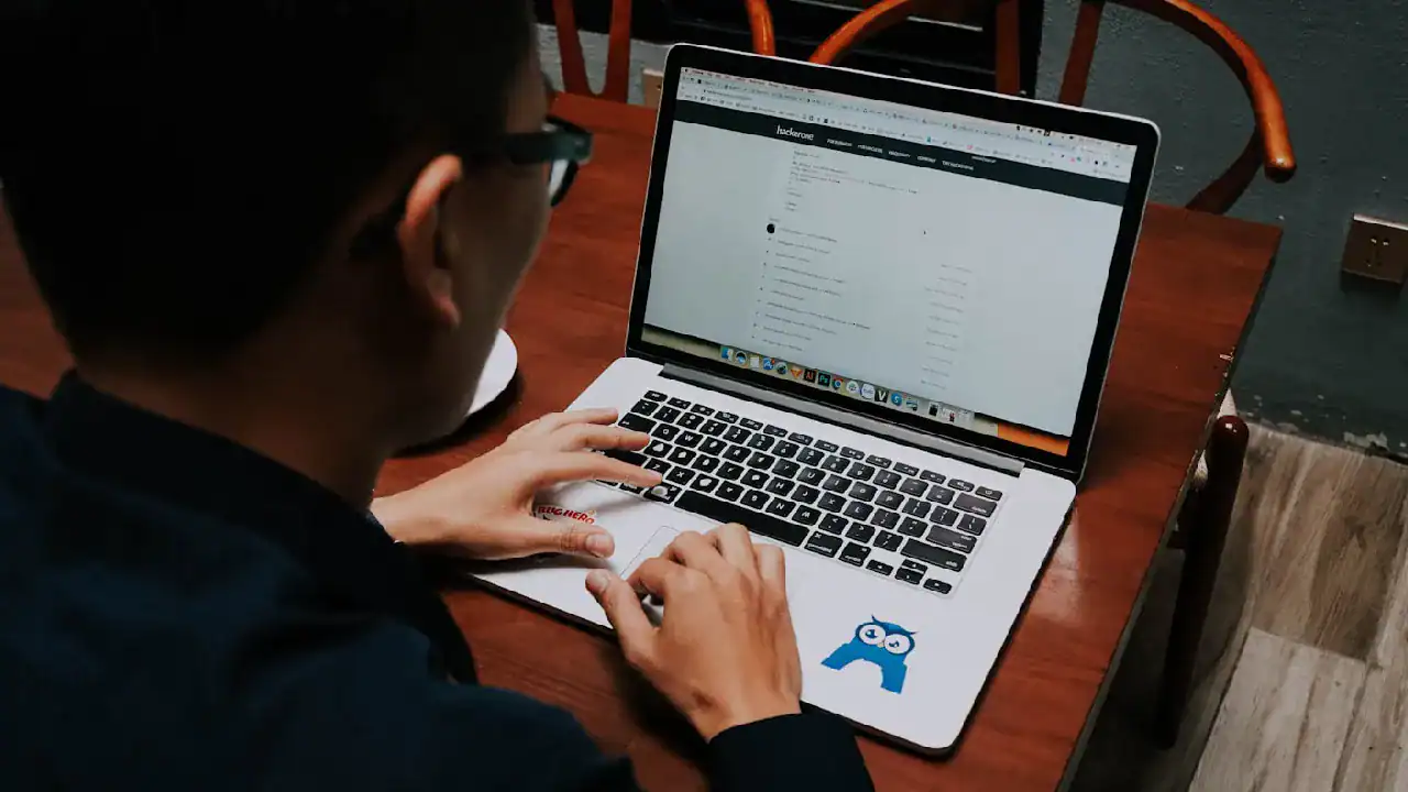 Accessible image of a person working on a laptop with Salesforce Service Cloud interface.