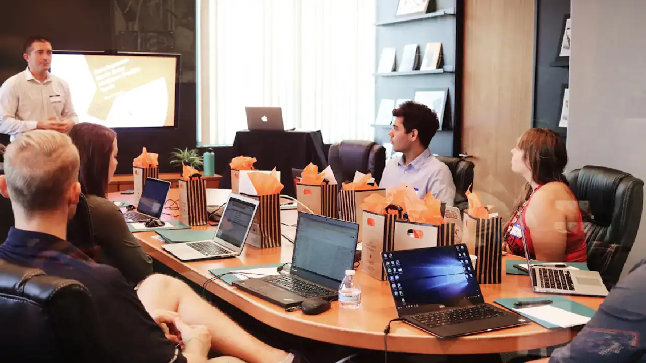 Professionals building and managing cloud networks in a modern conference room.
