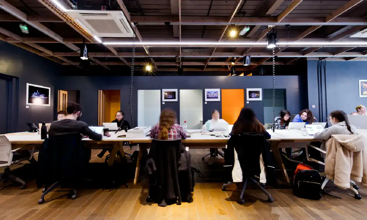 Group of professionals in a modern training room learning machine learning skills.