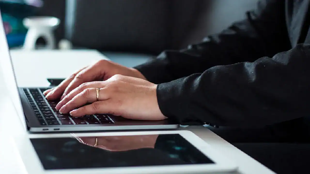 Person typing on a laptop for cloud security certification training.