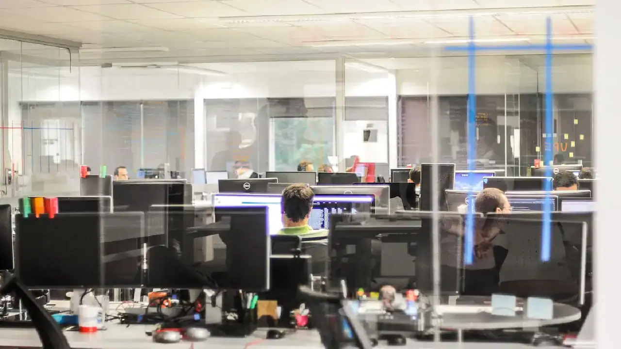 Modern computer lab with students studying IT certifications.